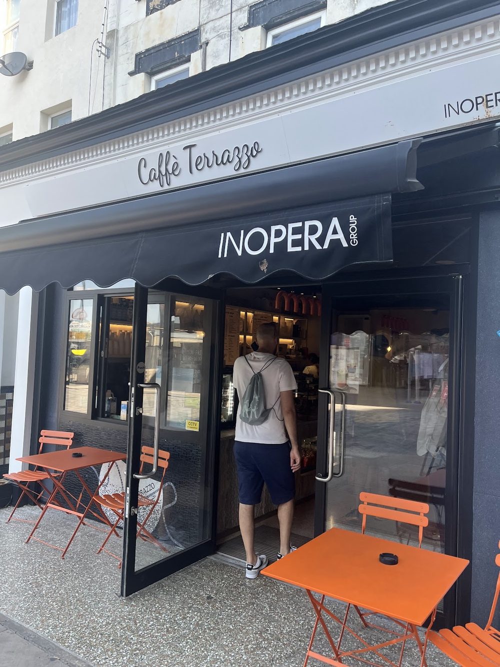 The Caffè Terrazzo shopfront on Manor Road with orange pavement tables outside.